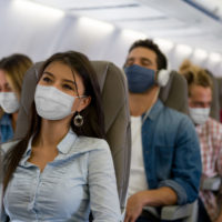Masked people on a plane.